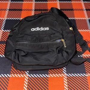 Mini ADIDAS back pack , black with white lettering and gold hardware , zipper